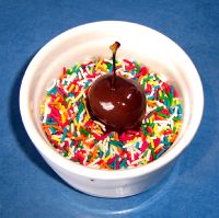 Dip cherry into sprinkles