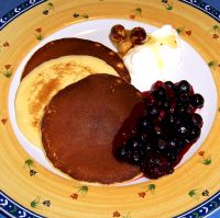 Yoghurt Pancakes with Roasted Hazelnut Honey and Berry Coulis.